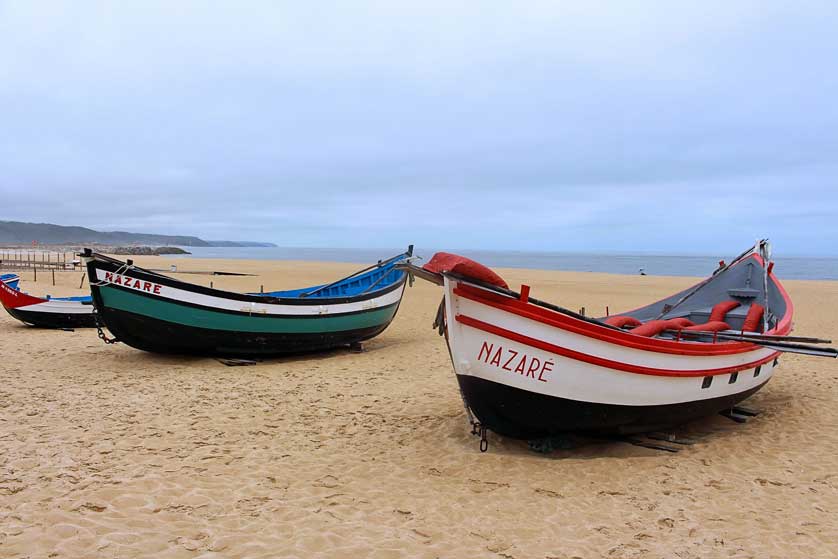 Nazaré - traditional fishing boats on the beach.