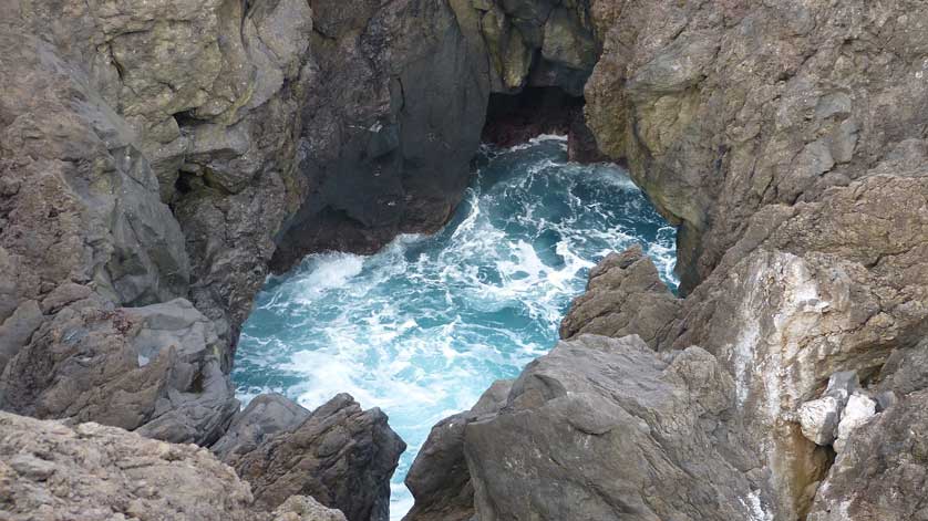 Natural pools are formed in the black, volcanic, basalt rocks.