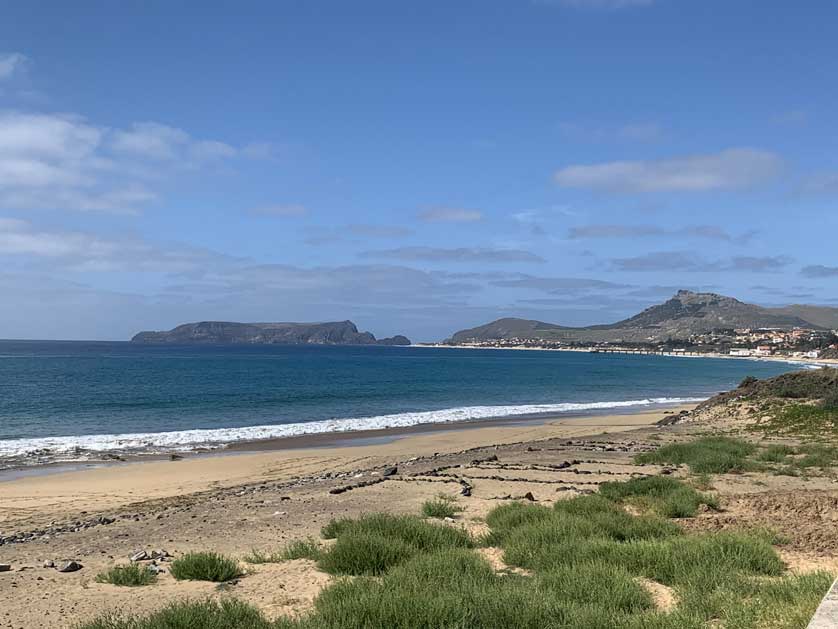 View of the ocean and beach on the road to Vila Baleira from the port.
