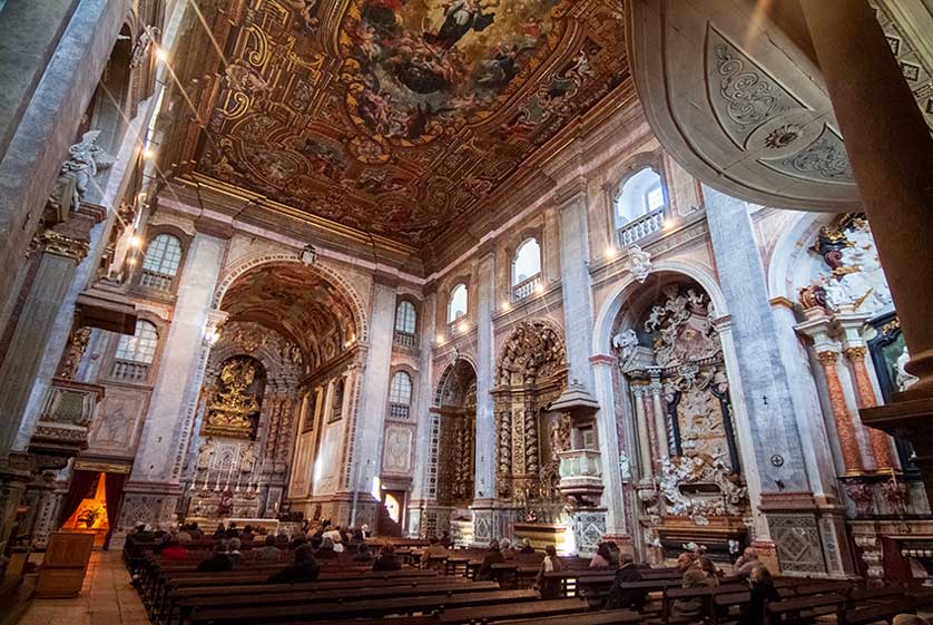 The ornate interior of the church with painted ceiling.
